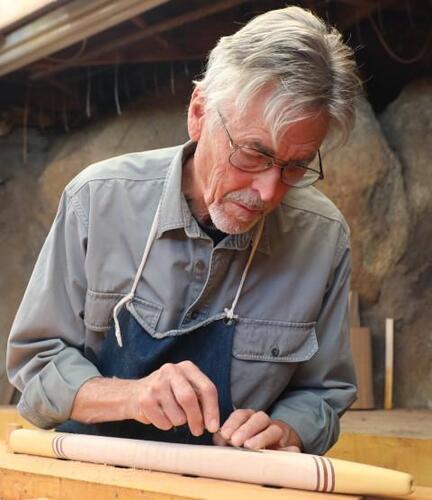 John Stillwell making a native american style flute